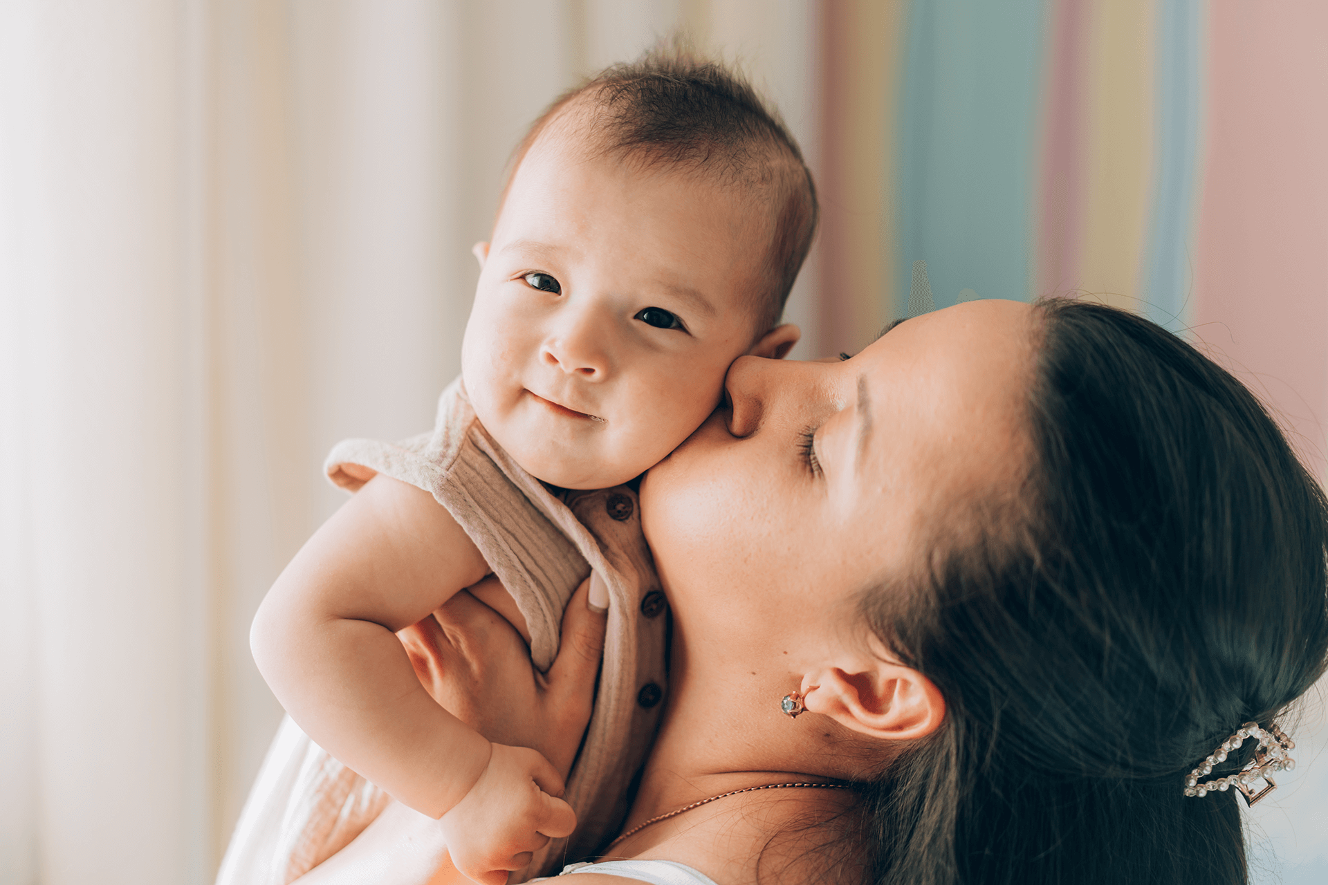 woman kissing baby